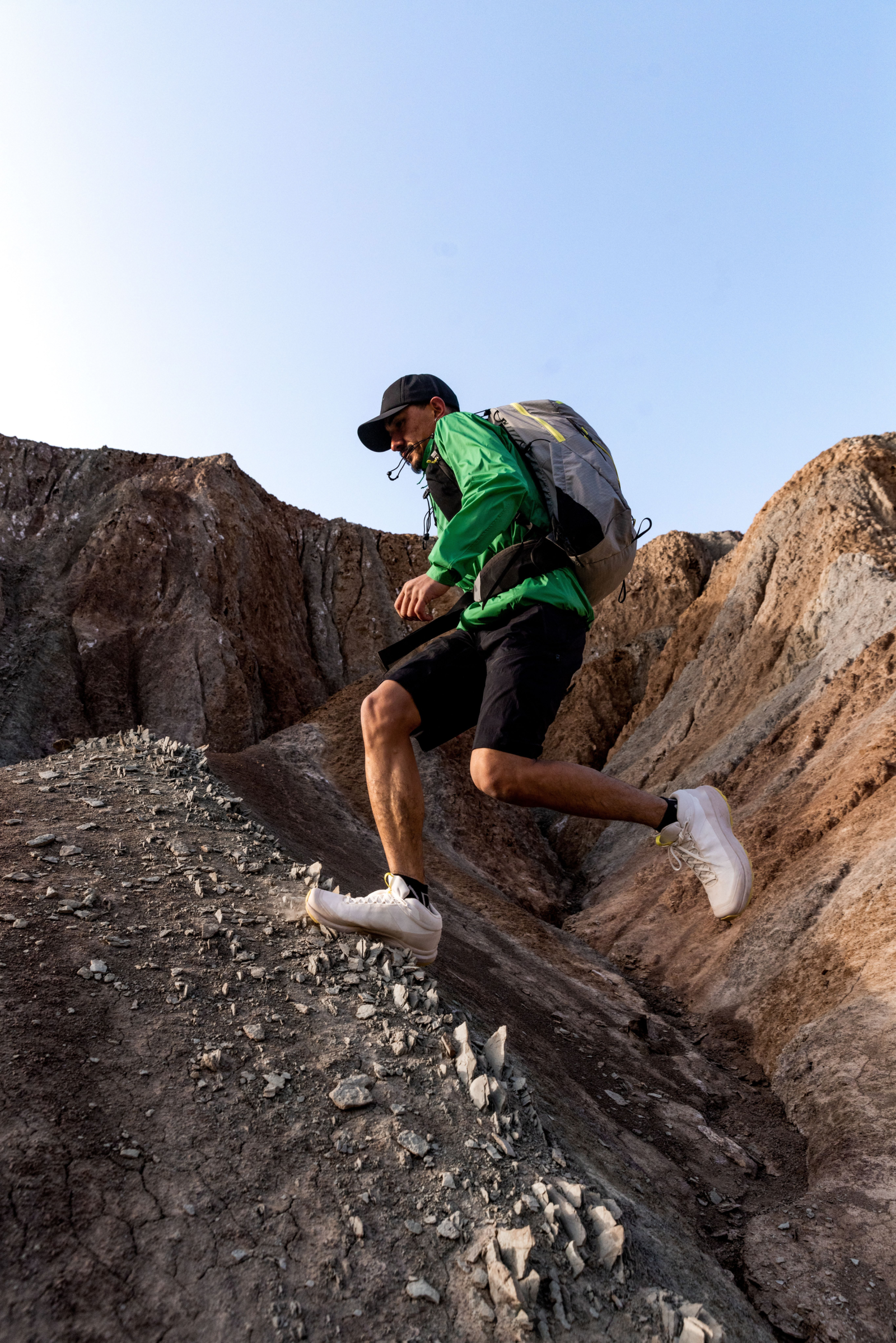 Trail runner moving through a mountain landscape